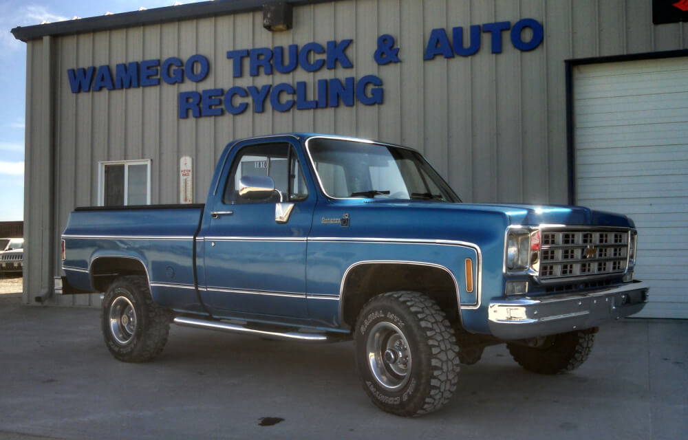 blue truck in front of the wamego truck and auto recycling shop